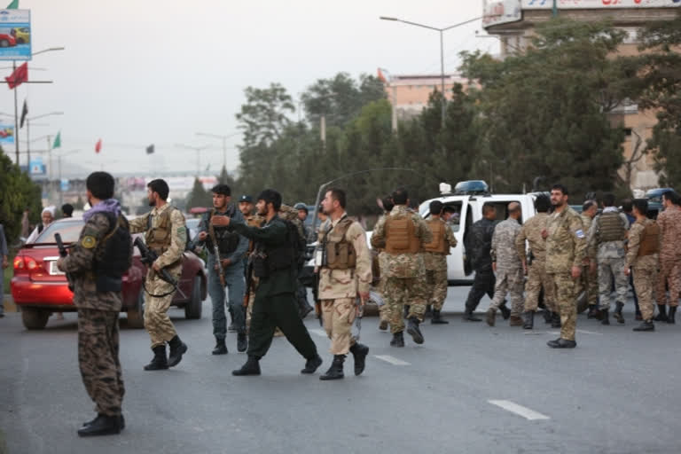 Afghan security force members are seen at the site of a bomb attack in Kabul