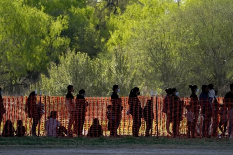 migrants are seen in custody at a U.S. Customs