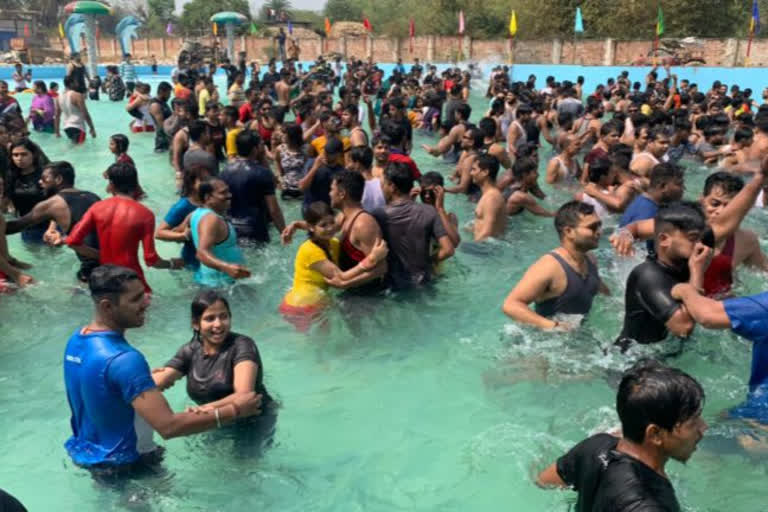 people are violating corona guidelines in water park in ghatshila