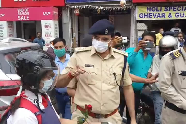 Police officers giving flowers to people