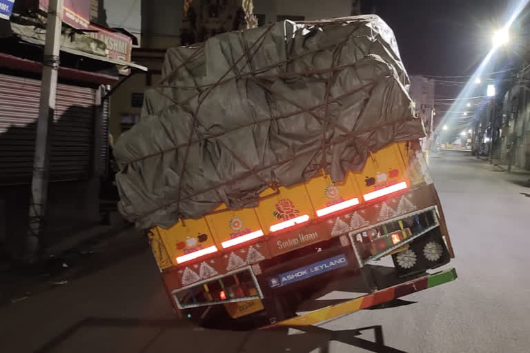 Truck stuck in a pothole on the road