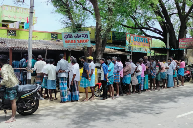 drinkers queue before liquor shops in palasamudram