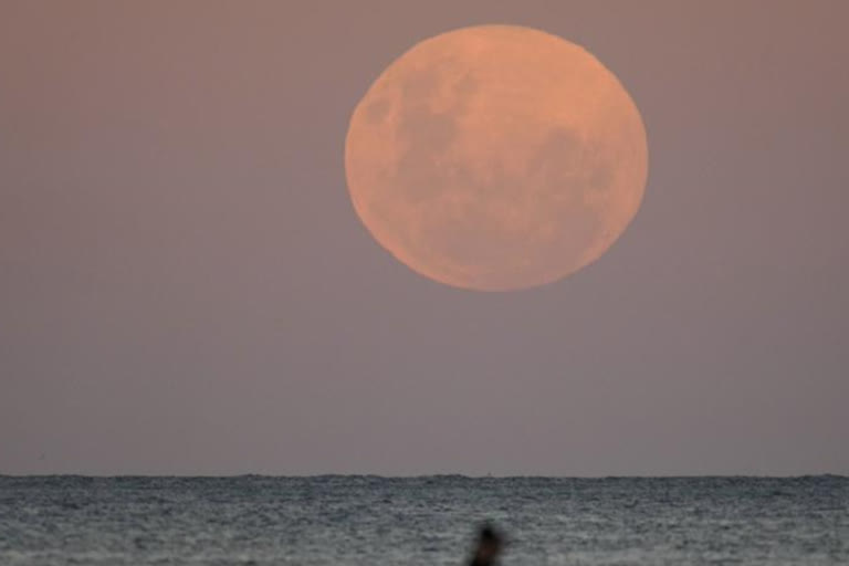 Glittering moon rises ahead of super blood moon