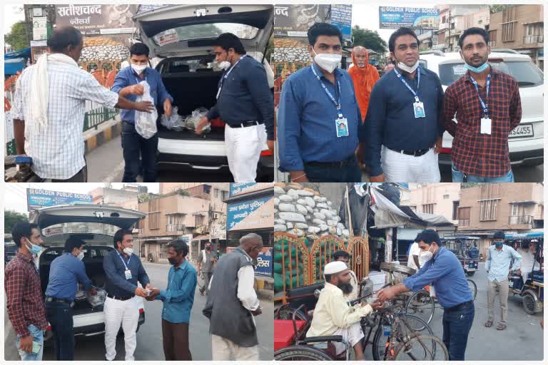 doctors of anand hospital distributing food among the poor people