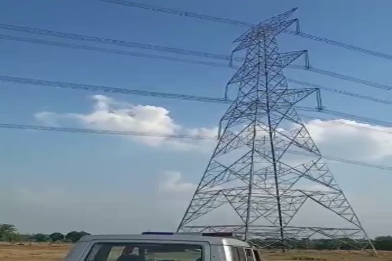 man climbed on electric tower