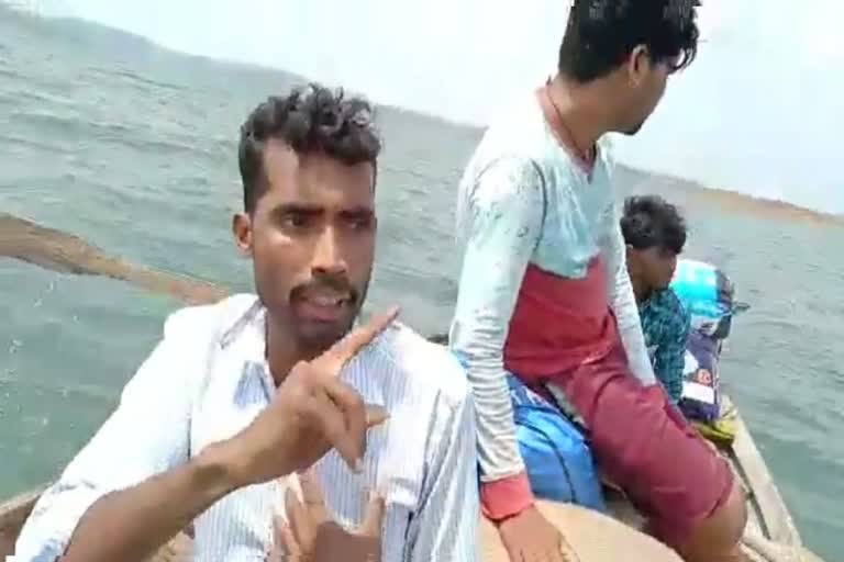 villagers crossing the bargi dam in jabalpur