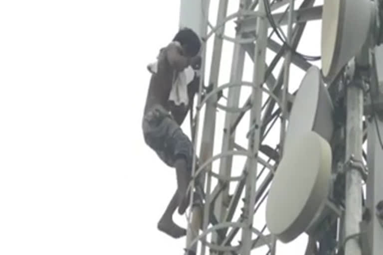 Young man climbs tower demanding money for wine