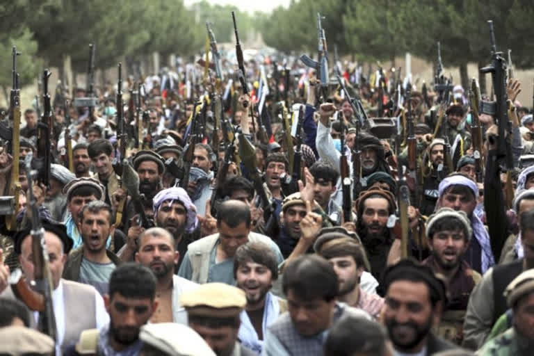 Afghan militiamen join Afghan defense and security forces during a gathering in Kabul