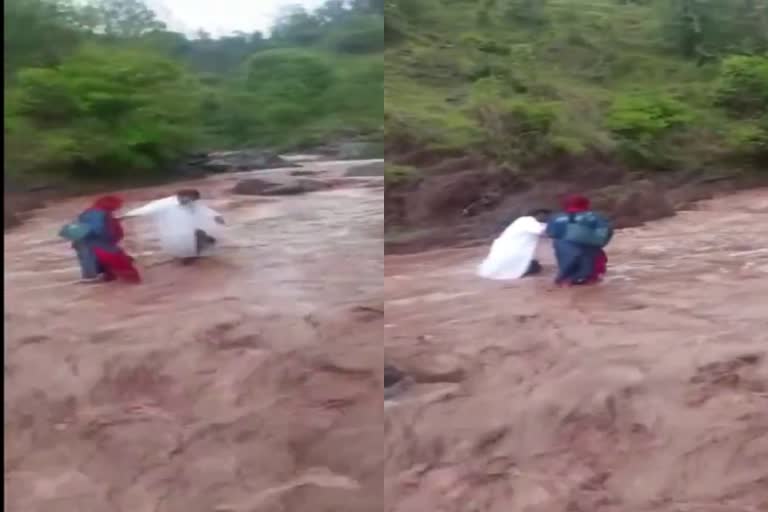 Health workers cross a river