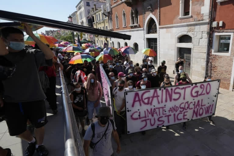 Demonstrators holds rainbow umbrellas during a protest against the G20 Economy and Finance ministers and Central bank governors' meeting in Venice, file photo