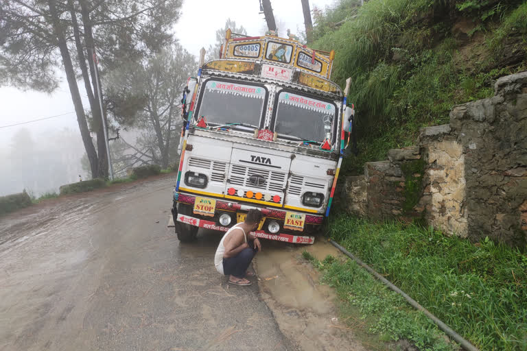 A truck laden with cement sunk in a mud-filled drain in Karsog