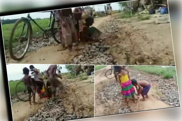 Childrens repair roads by collecting stones, bricks from around