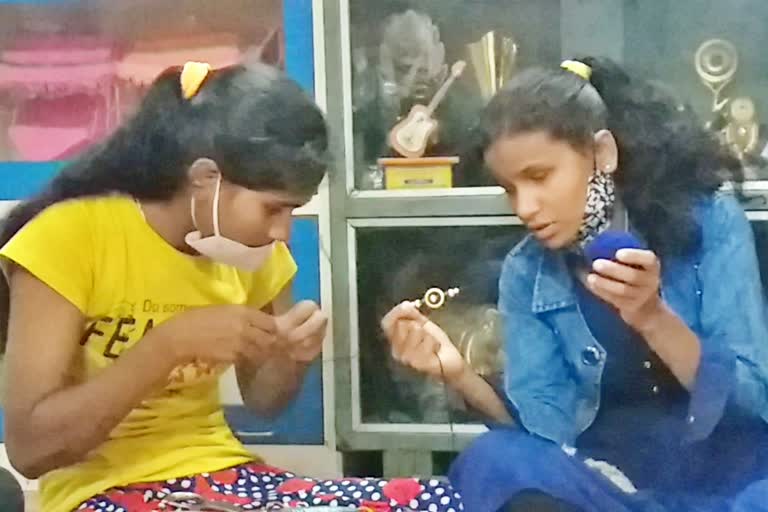 Blind girls making rakhi