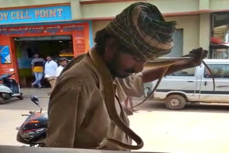 Begging at Pavagada with snakes around the neck