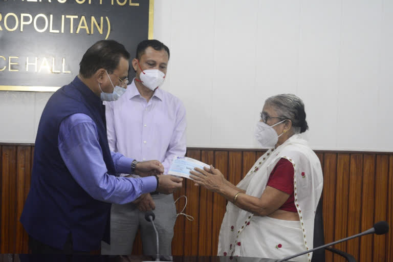 chandra mohan patowary distributes cheque to widow