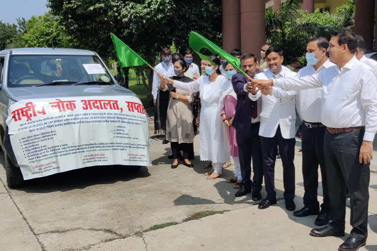 mobile vans to promote the national lok adalat in noida