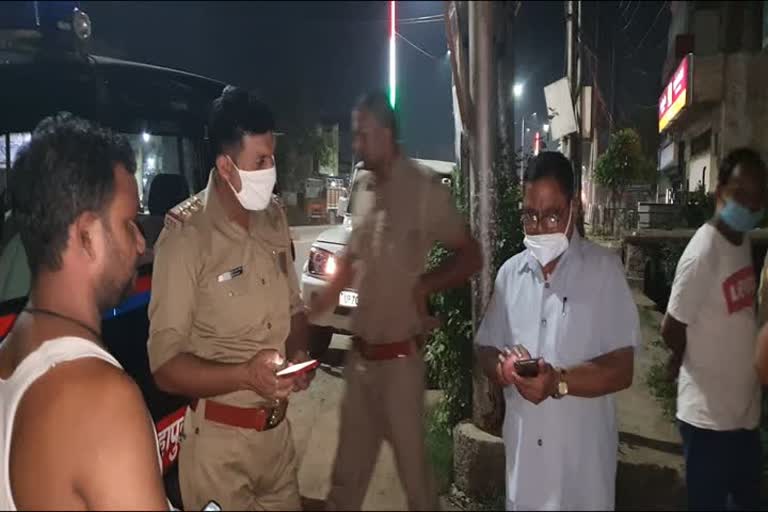 शराब की दुकान के बाहर खड़े पुलिस अधिकारी.