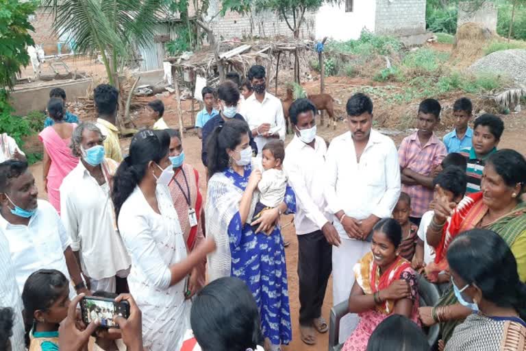 District Panchayat CEO Fouzia Taranum picking up a crying baby in koppal district
