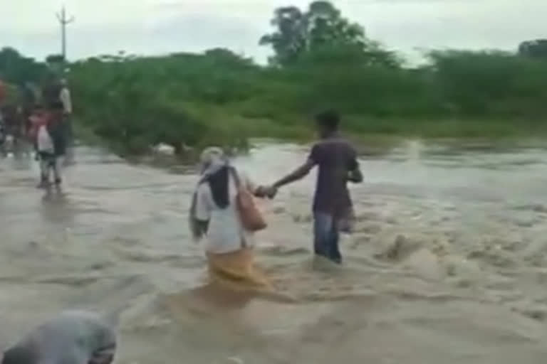 health worker crossed the flood