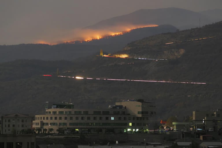 In this Saturday, Oct. 31, 2020 file photo, forest burns in the mountains after shelling by Azerbaijan's artillery during a military conflict outside Stepanakert, the separatist region of Nagorno-Karabakh. Armenia accused neighboring Azerbaijan of systematically promoting ethnic hatred against Armenia citizens, as the two nations that fought a six-week war last year faced off at a United Nations court on Thursday Oct. 14, 2021