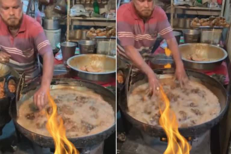 MAN DIPS HIS HAND IN BOILING HOT OIL WHILE MAKING FRIED CHICKEN