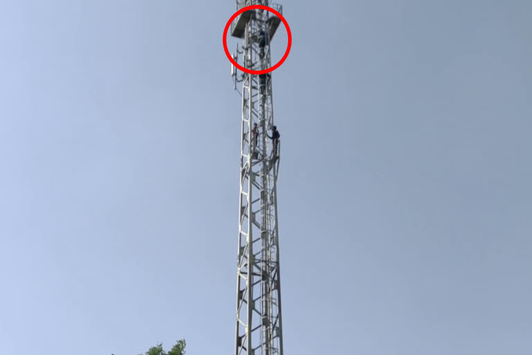 man-climbed-on-mobile-tower