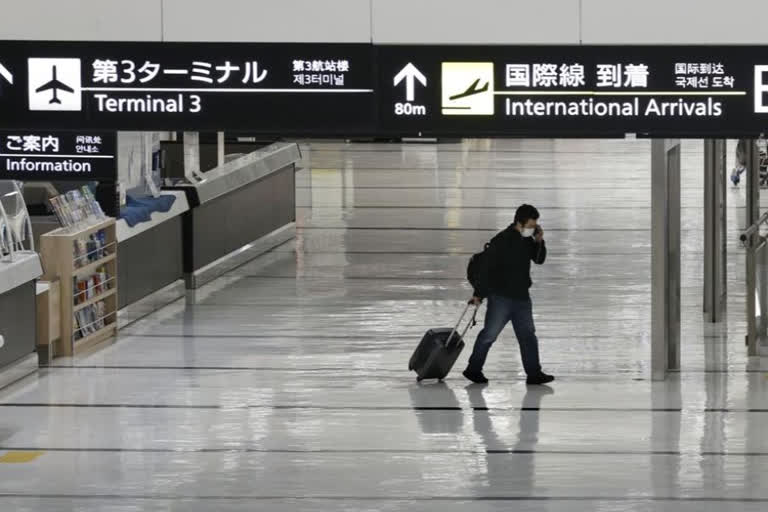 Japan suspends new flight reservations as omicron spreads
