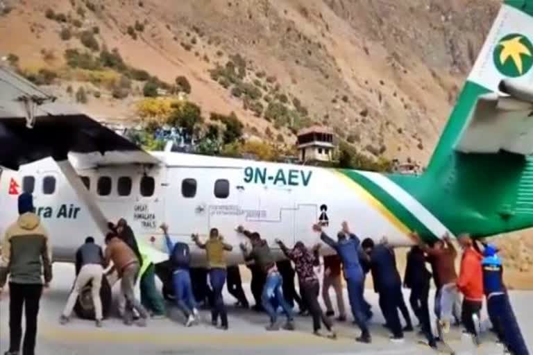 Passengers push airplane