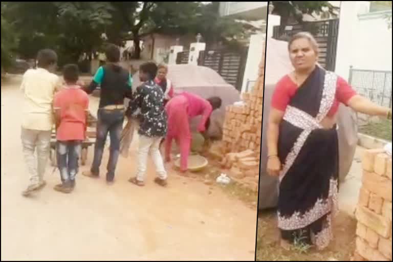 A teacher does her house construction work with school students