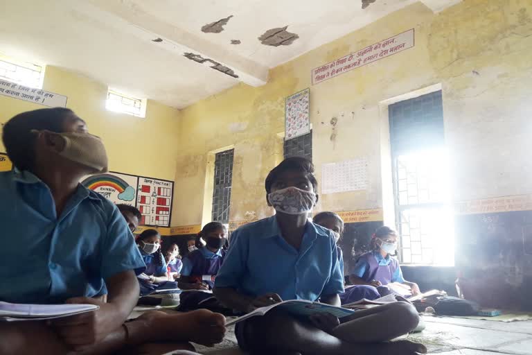 Students studying in dilapidated school building
