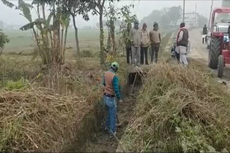 villagers cleaning canal
