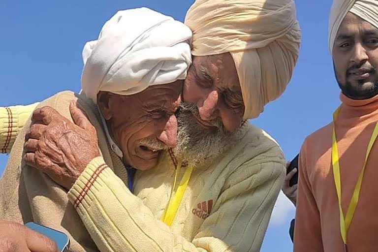 Brothers, Sadiq (left) and Sikka, reunite at Kartarpur Sahib on Monday.