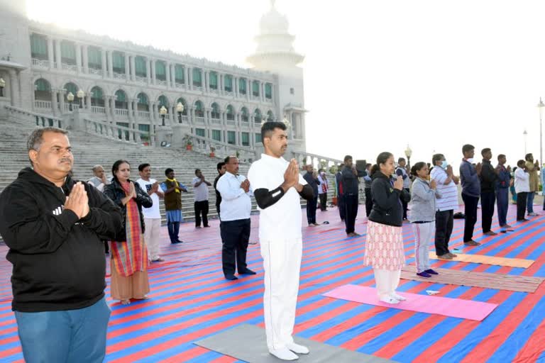 surya namaskar in front of Suvarna Soudha