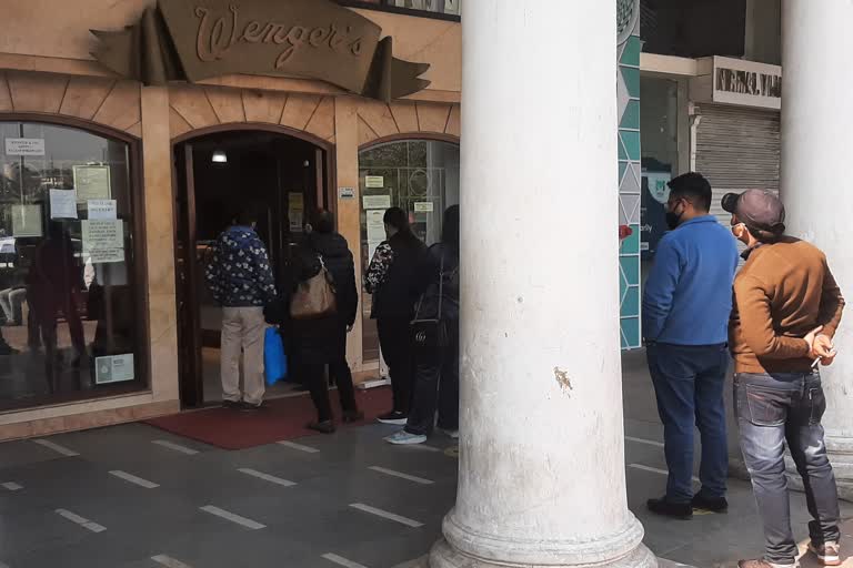 Crowds gathered as soon as Connaught Place opened people standing in line