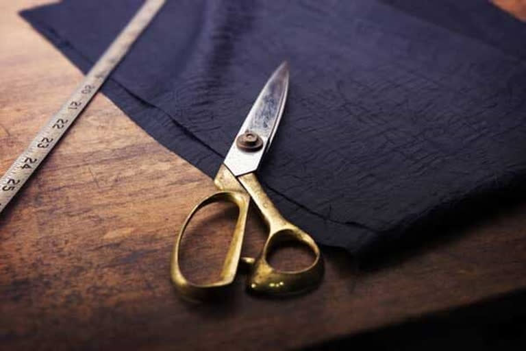 gent tailor taking measurements for female constables