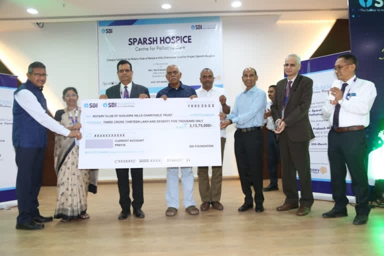 SBI officials presenting checks to Rotary Club members