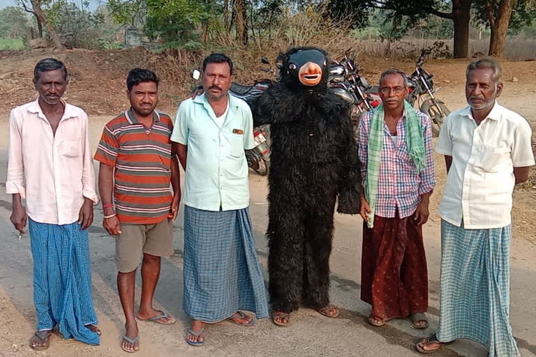 BEAR COSTUME KEEPS MONKEYS IN CHECK