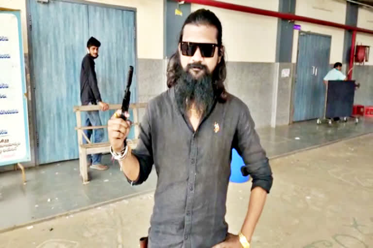 young man hulchal with a gun at the RRR movie theater in east godavari district