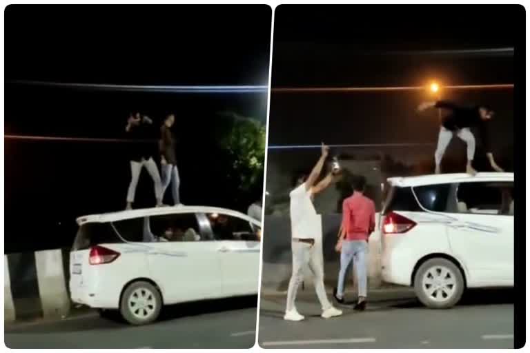 Youth dance on roof of car