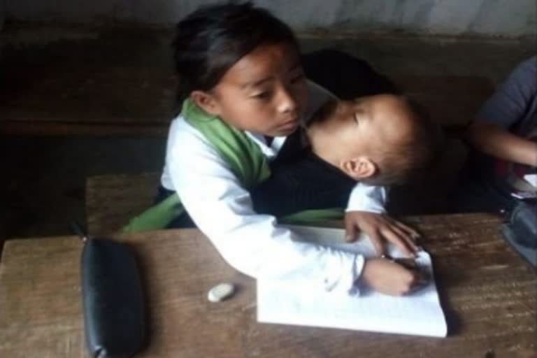 A girl attends school with sister