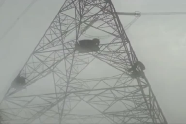 satna farmers sitting high tension tower