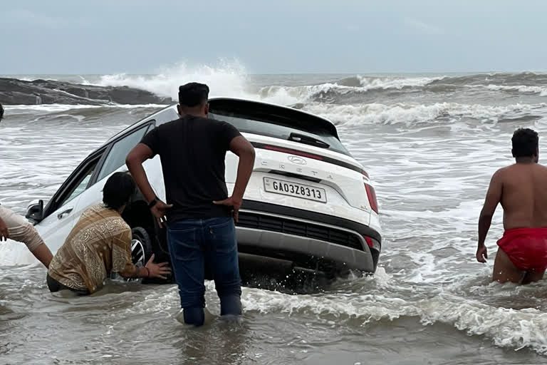 tourists car got stuck in the sea water in Goa  car ride in vagator beach at Goa  Goa crime news  ಗೋವಾದ ಸಮುದ್ರ ದಡದಲ್ಲಿ ಸಿಲುಕೊಂಡ ಕಾರು  ಗೋವಾದ ವಗಟೋರ್​ ಬೀಚ್​ನಲ್ಲಿ ಕಾರ್​ ರೈಡ್​ ಗೋವಾ ಅಪರಾಧ ಸುದ್ದಿ