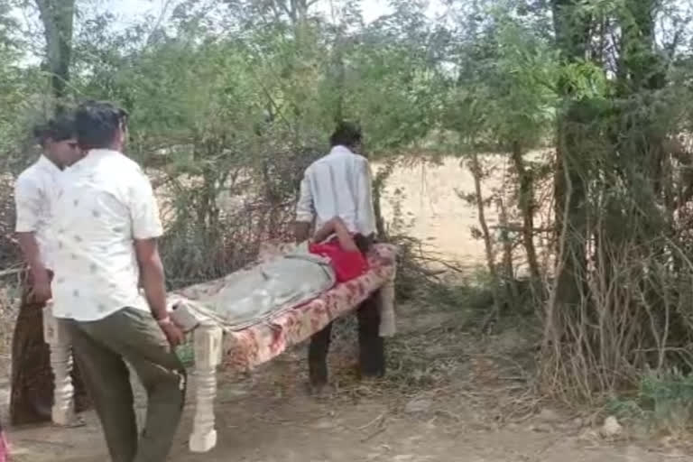 Family carries new born and the mother through other's fields in Jalore