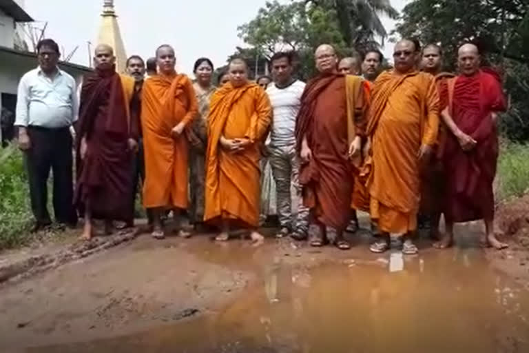 buddhist monks protest demanding road repairs