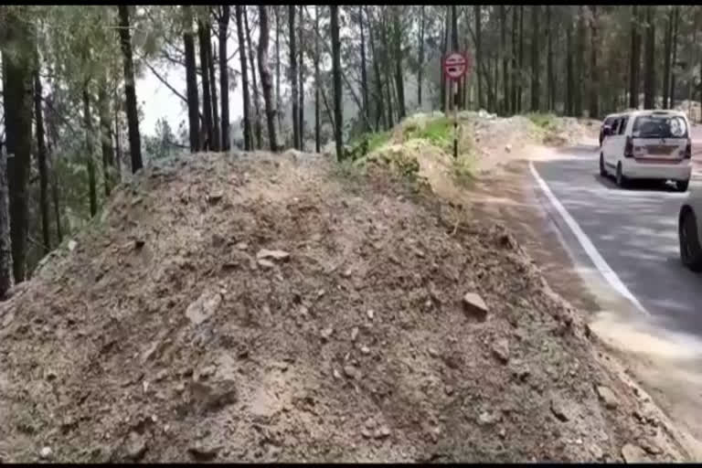 Illegal dumping of soil along the road in Almora