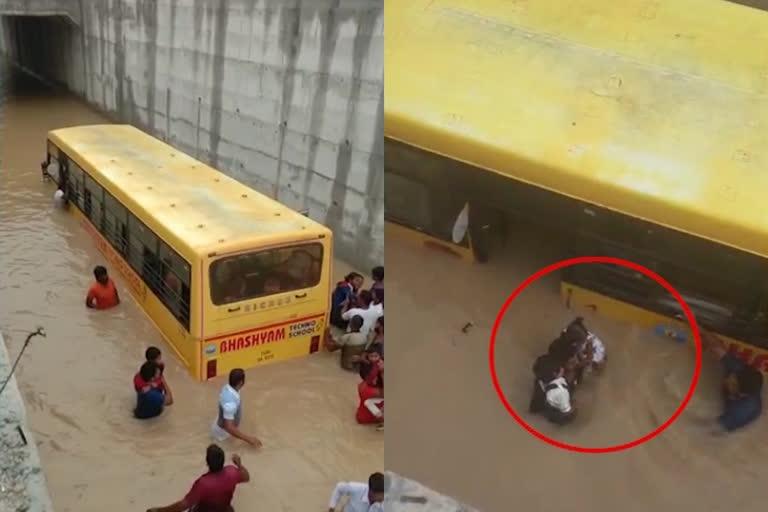 Praivate School bus stuck in flood water but Students are safe at mahaboobnagar