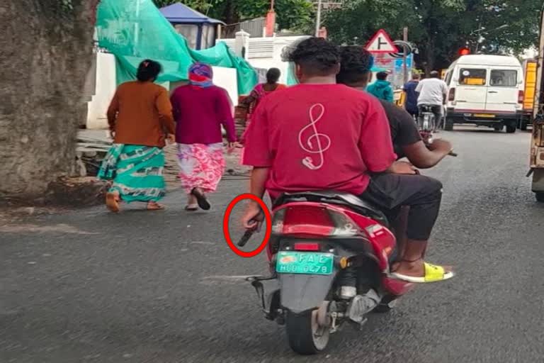 Miscreants bike  riding with gun