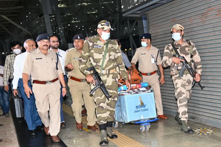 security personnel carrying ballot box