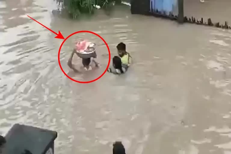 a-man-saved-2-month-old-baby-in-bahubali-style-in-marriwada-floods-in-telangana