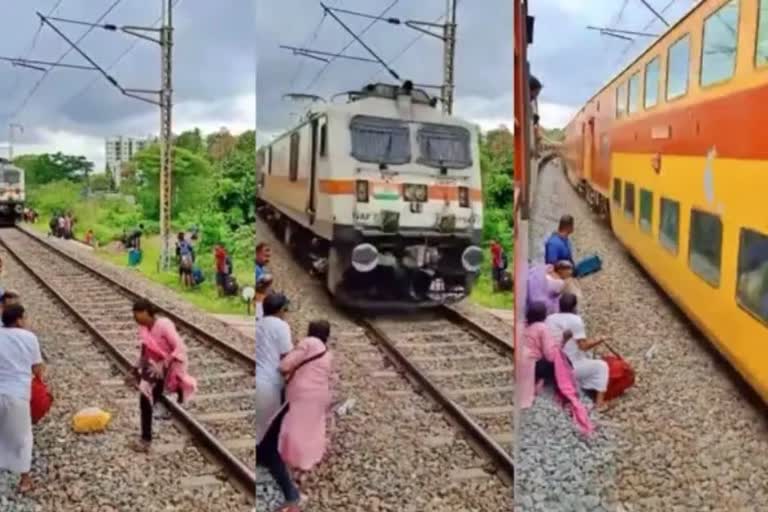 Viral video Reckless train passengers crossing track  രണ്ട് ട്രെയിനുകള്‍ക്ക് ഇടയില്‍പ്പെട്ട് യാത്രികര്‍  റെയില്‍ ട്രാക്ക് മുറിച്ചുകടക്കുന്നതിനിടെ മറ്റൊരു ട്രെയിന്‍  Reckless train passengers crossing track  Viral video  train passengers Viral video